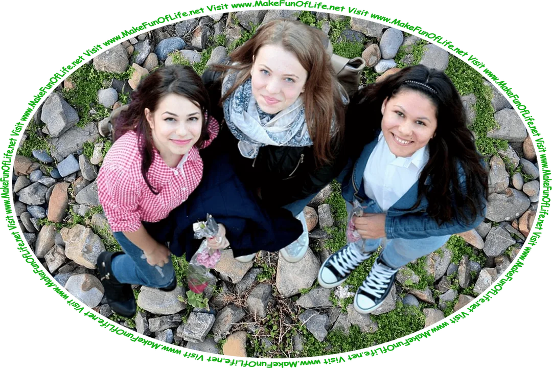 Picture of three happy smiling young women, who are friends, standing together outside, looking up as their picture is taken from overhead, and the words, ‘Visit www.MakeFunOfLife.net.’