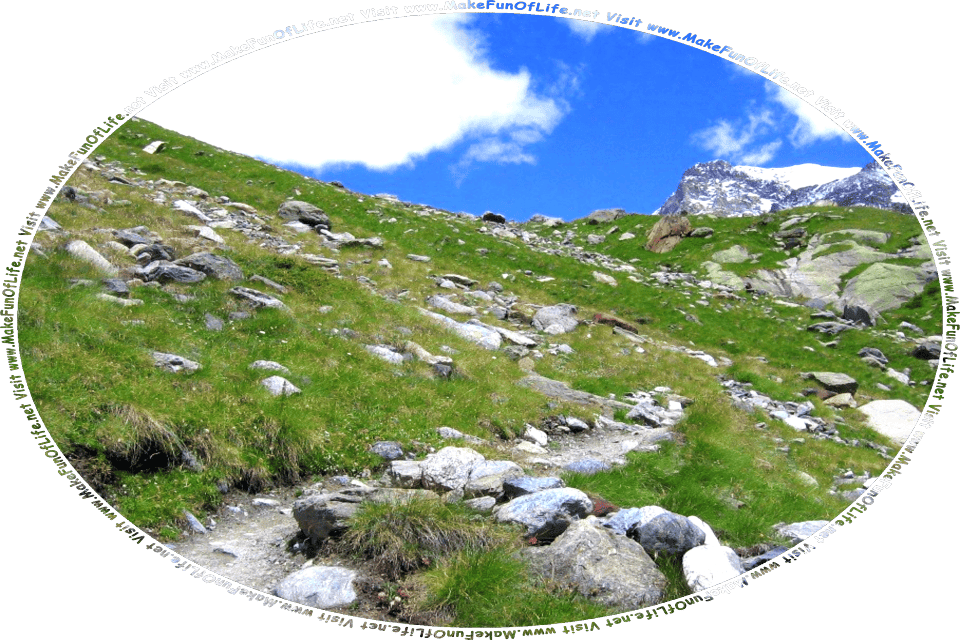 Picture of a rock-strewn dirt footpath leading up a hillside that is covered with green grass, a blue sky with fluffy white clouds above, and the words, Visit www.MakeFunOfLife.net.