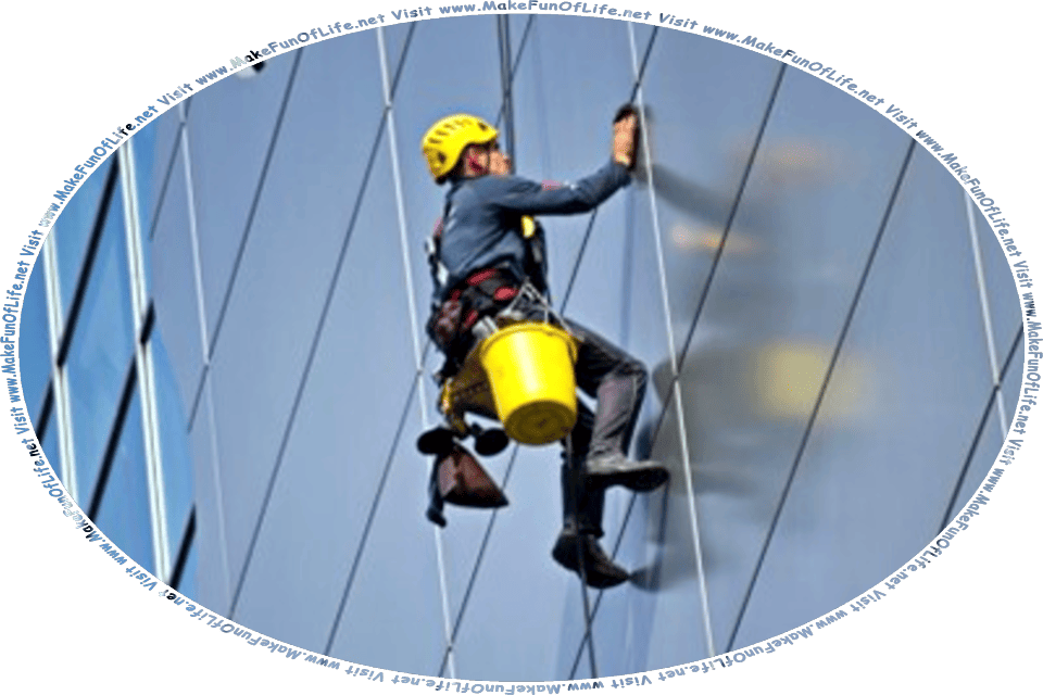 Picture of a man hanging from a cable on the outside of a skyscraper, cleaning the exterior of the building, and the words, Visit www.MakeFunOfLife.net.