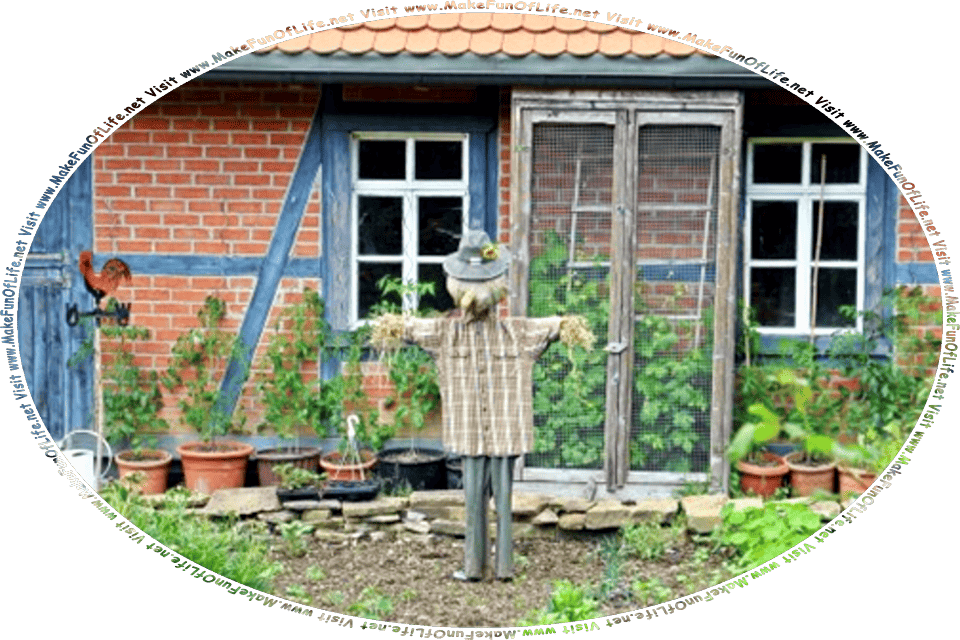 Picture of a scarecrow made of old clothes stuffed with straw, standing in a garden near a garden shed, and the words, Visit www.MakeFunOfLife.net.