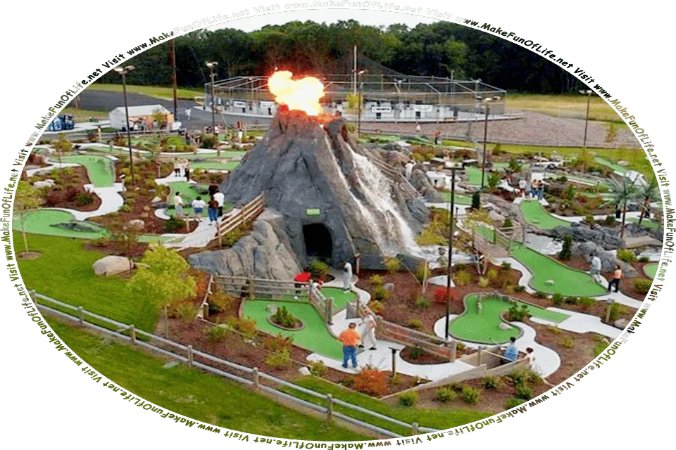 Picture of a miniature golf course featuring a volcanic mountain with a cave in its side, small putting greens of artificial green grass of various shapes and sizes, connected by walkways, interspersed with small trees and bushes, with the entire course bordered by real green grass and a few small trees, and the words, Visit www.MakeFunOfLife.net.