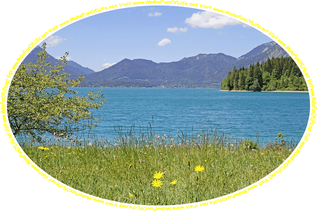 Picture of a wilderness area, with a serene blue lake, purple-hued mountains, pine trees, green grass, flowering plants with yellow and lavender blossoms, a clear blue sky with a few fluffy white clouds, and the words, ‘Visit www.MakeFunOfLife.net.’