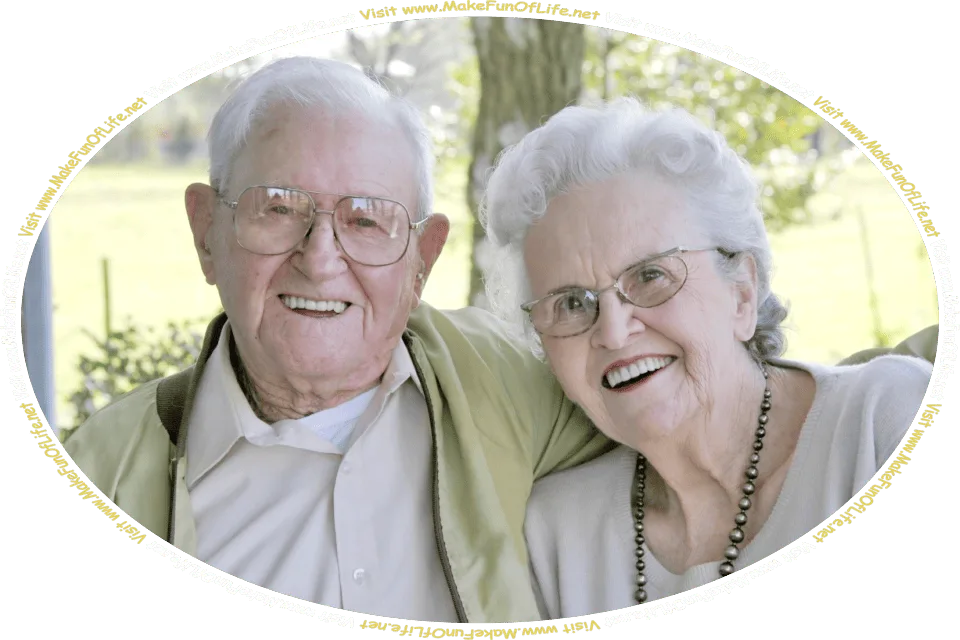 Picture on a bright sunny day of a happy smiling married couple, with a green leafy tree, green leafy bush, and green grass in the background, and the words, ‘Visit www.MakeFunOfLife.net.’