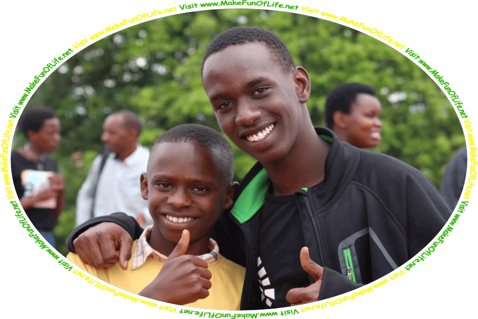 Picture of two happy smiling young men friends standing side-by-side, giving a thumbs-up hand gesture, as a family gathering is happening in the background, and the words, ‘Visit www.MakeFunOfLife.net.’