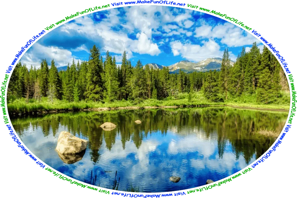 Picture of a of a clear blue mountain lake surrounded by green grass and evergreen trees, with a blue sky and white fluffy clouds above, and the words, ‘Visit www.MakeFunOfLife.net.’