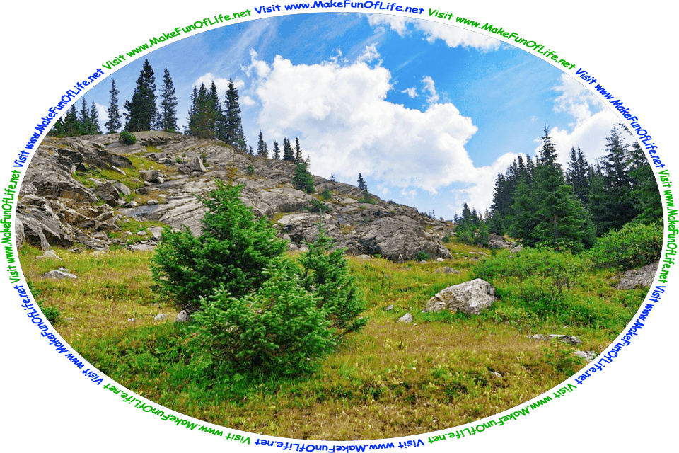 Picture as seen from below of a steep hillside, with rocks, green leafy trees and small green plants, a blue sky with fluffy white clouds above, and the words, ‘Visit www.MakeFunOfLife.net.’