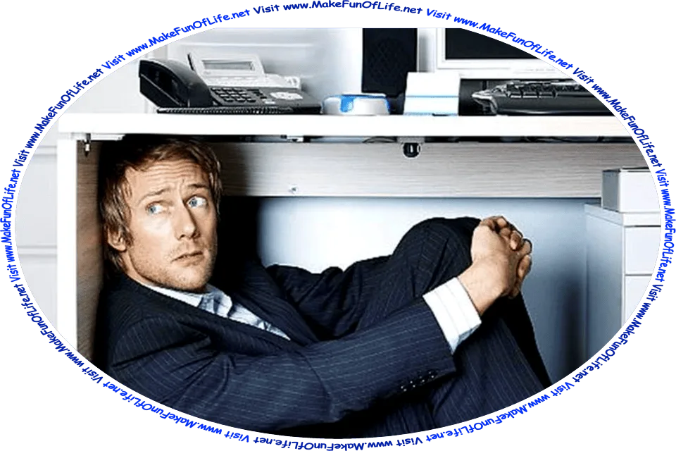 Picture of a man hiding under a desk in a workplace, and the words, ‘Visit www.MakeFunOfLife.net.’