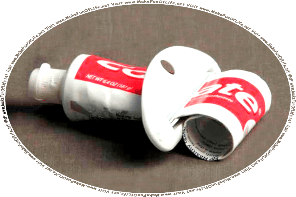 Picture of a nearly empty tube of toothpaste, with a plastic toothpaste tube squeezer gizmo placed on the tube, in order to squeeze every last bit of toothpaste out of it, and the words, Visit www.MakeFunOfLife.net.