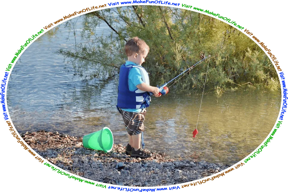 Picture of a boy standing on the bank of a river, holding a toy fishing pole with a toy plastic fish on the end of the line and a toy plastic bucket on the ground next to him, and the words, ‘Visit www.MakeFunOfLife.net.’