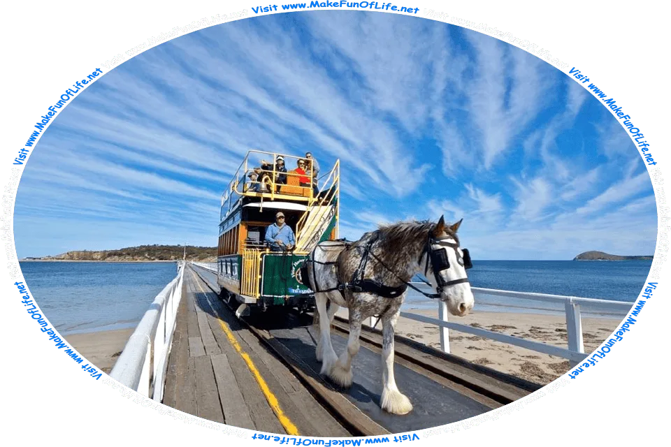 Picture of a horse-drawn single-car tram, being pulled over a railway track on a bridge connecting an island to the mainland, and the words, Visit www.MakeFunOfLife.net.