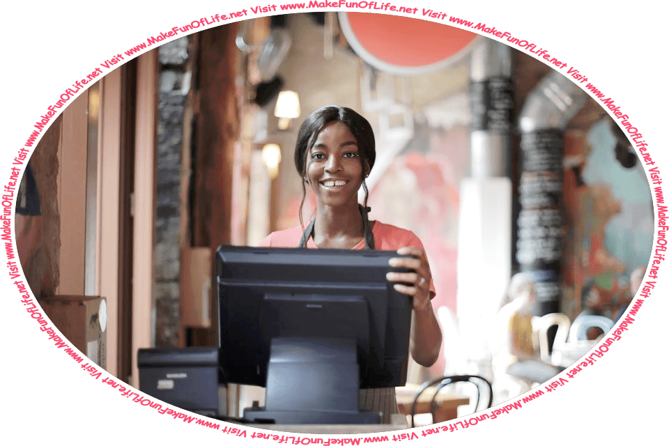 Picture of a happy smiling young woman working behind a cash register in a shop, and the words, ‘Visit www.MakeFunOfLife.net.’